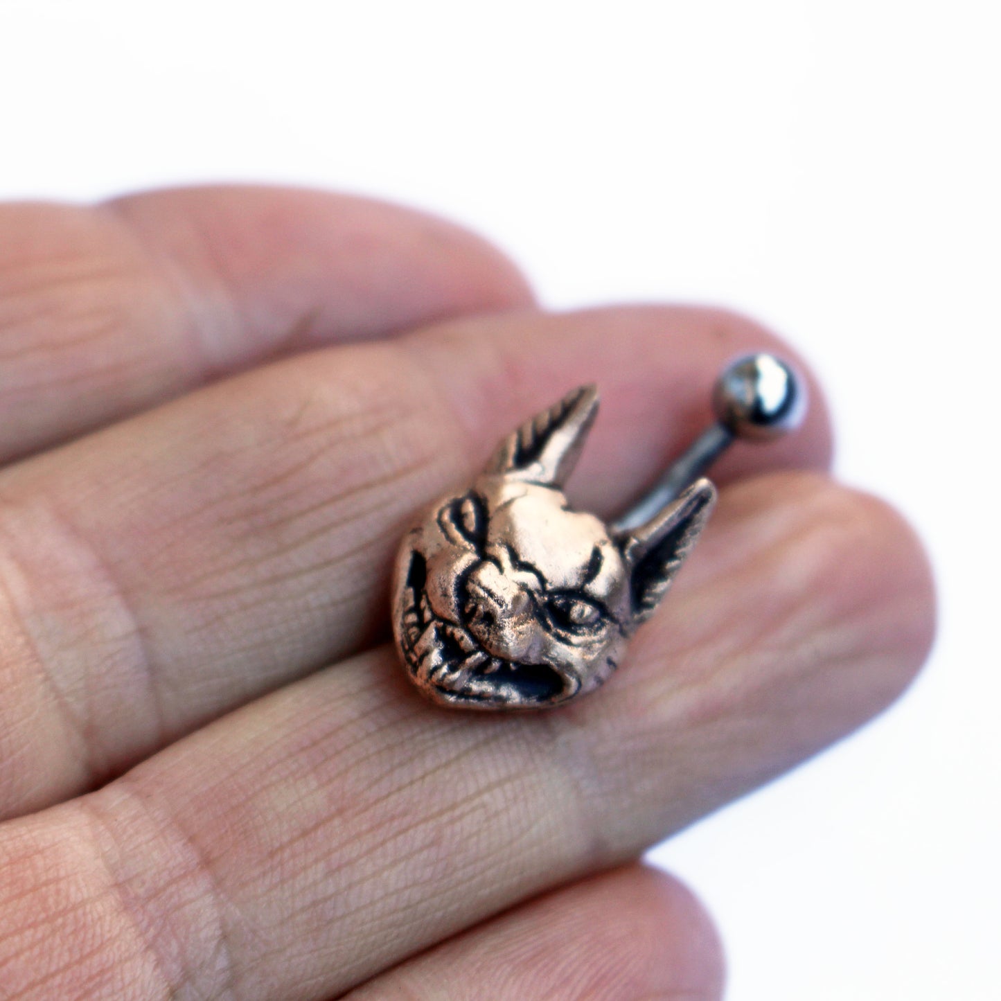 belly button ring with a bronze lynx cat on a titanium barbell.