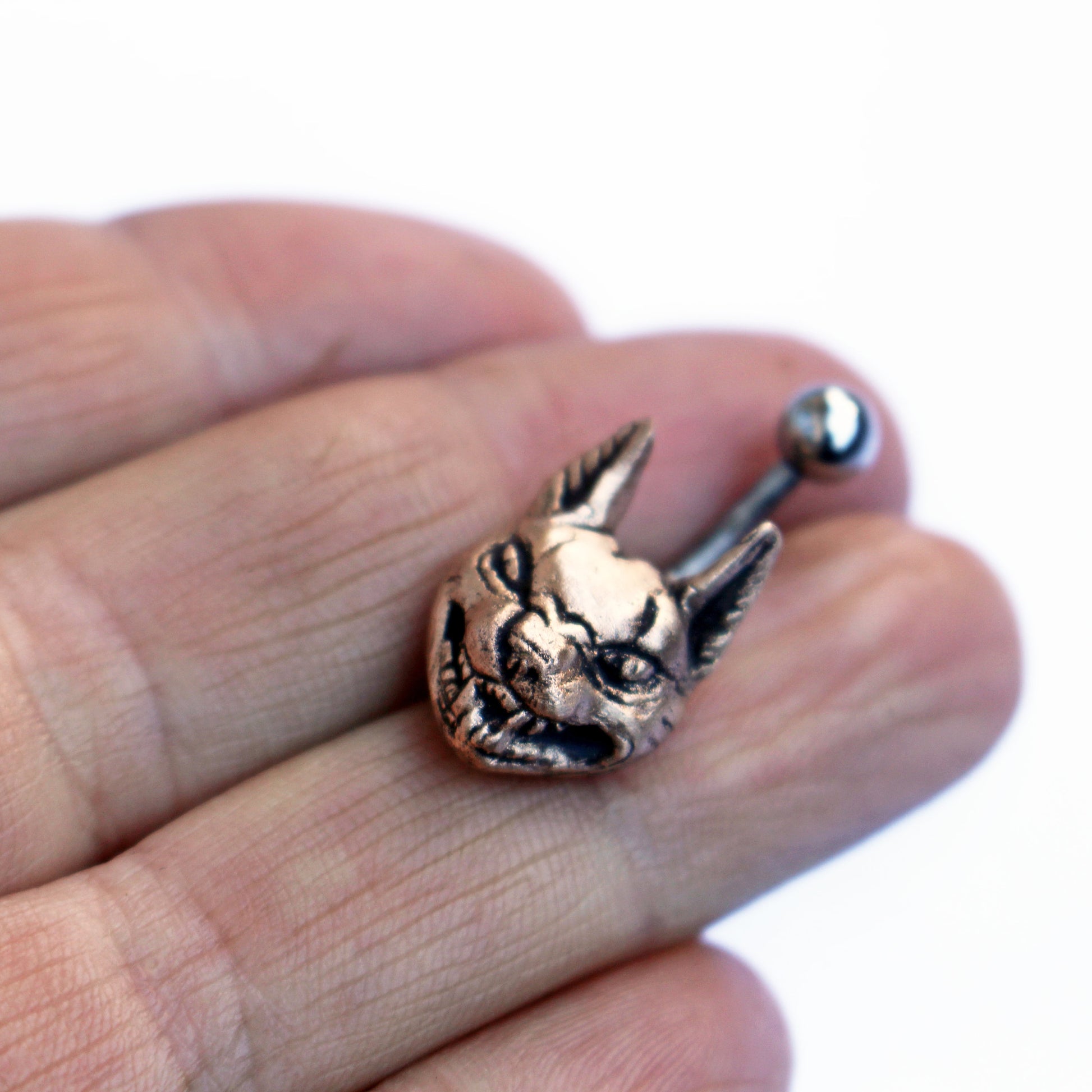 belly button ring with a bronze lynx cat on a titanium barbell.
