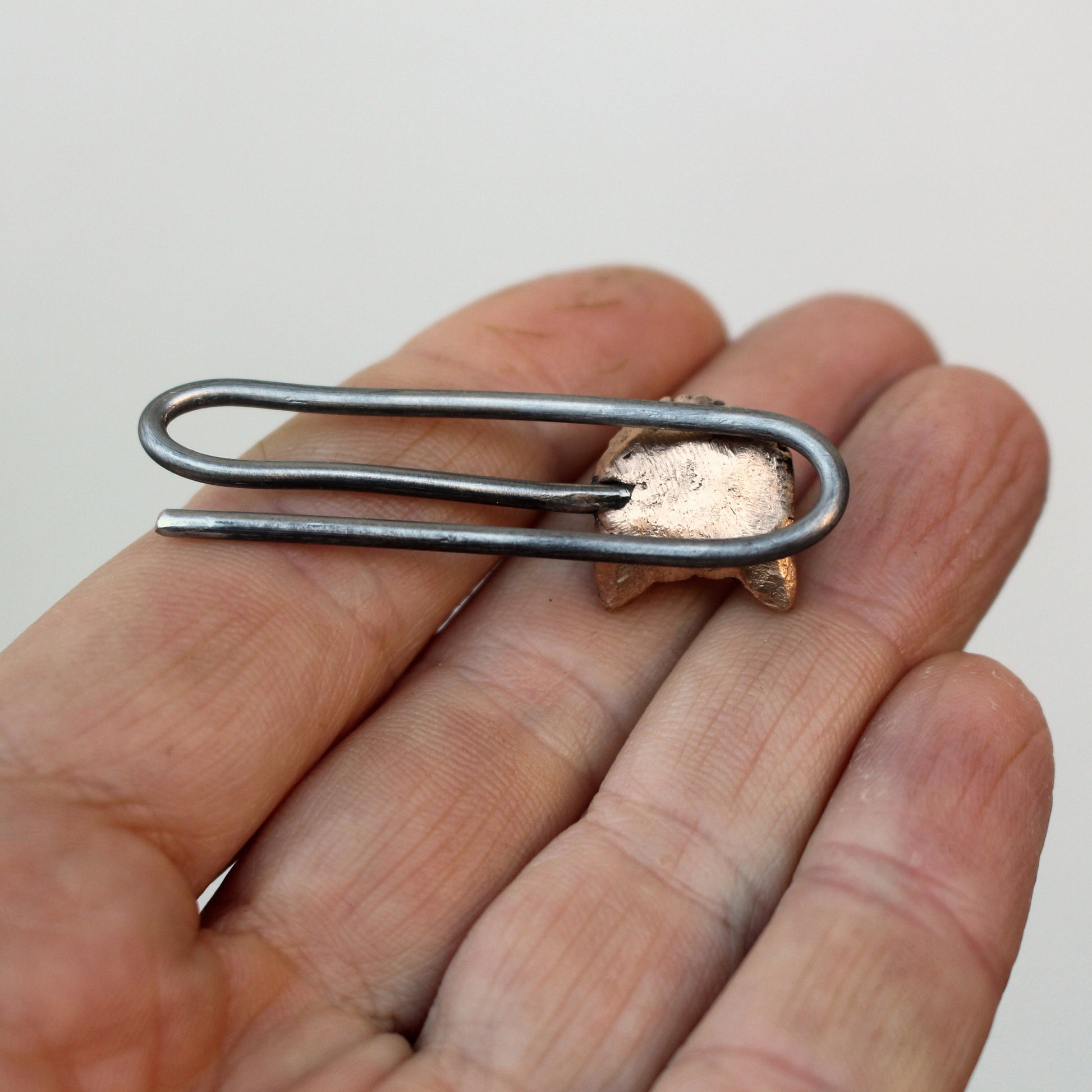 backside, A tie clip with a bronze wolf head