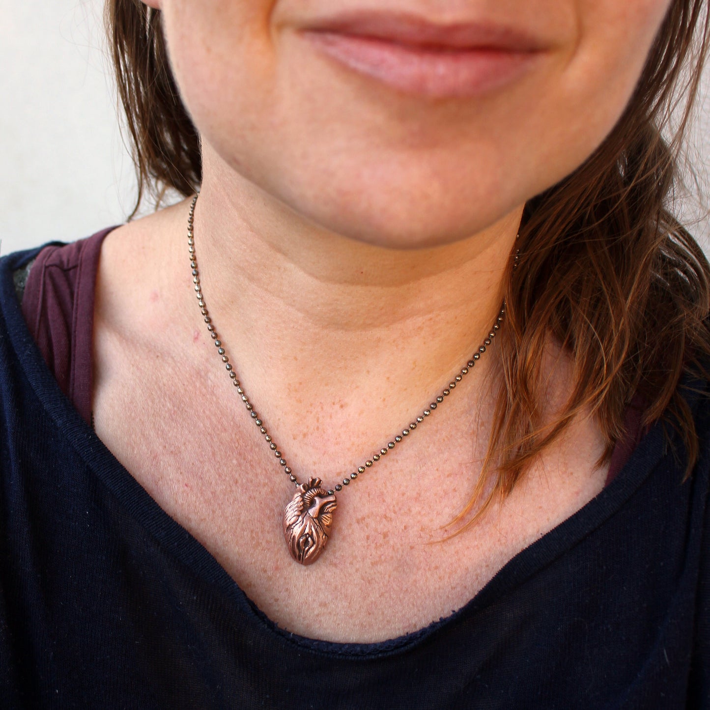 anatomical heart and vulva hybrid necklace made from copper and bronze