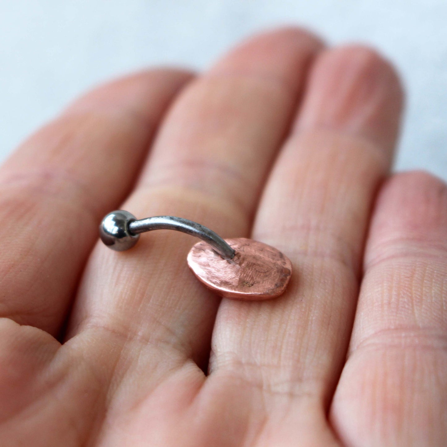 backside, titanium navel piercing with a copper vagina pussy