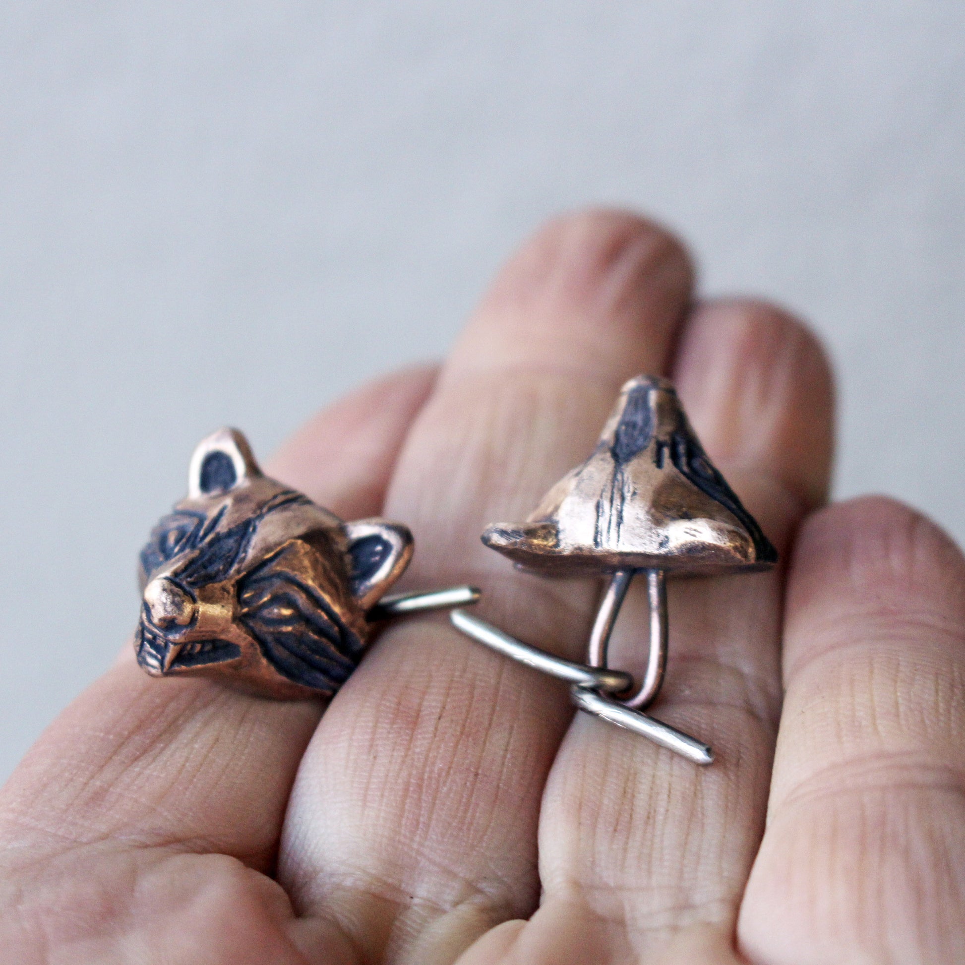 bronzeracoon head cuff links