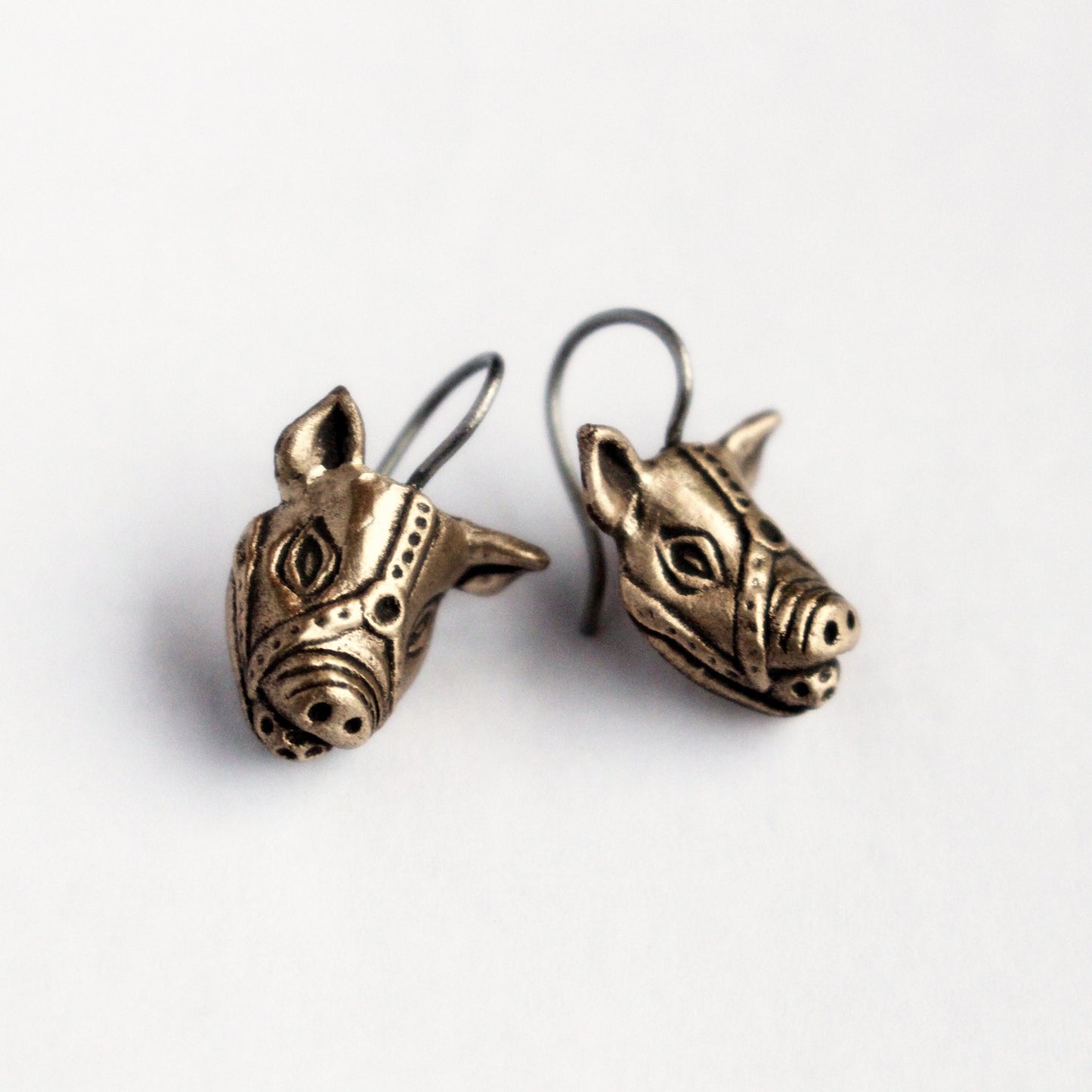 kinky pig earrings with a ball gag harness