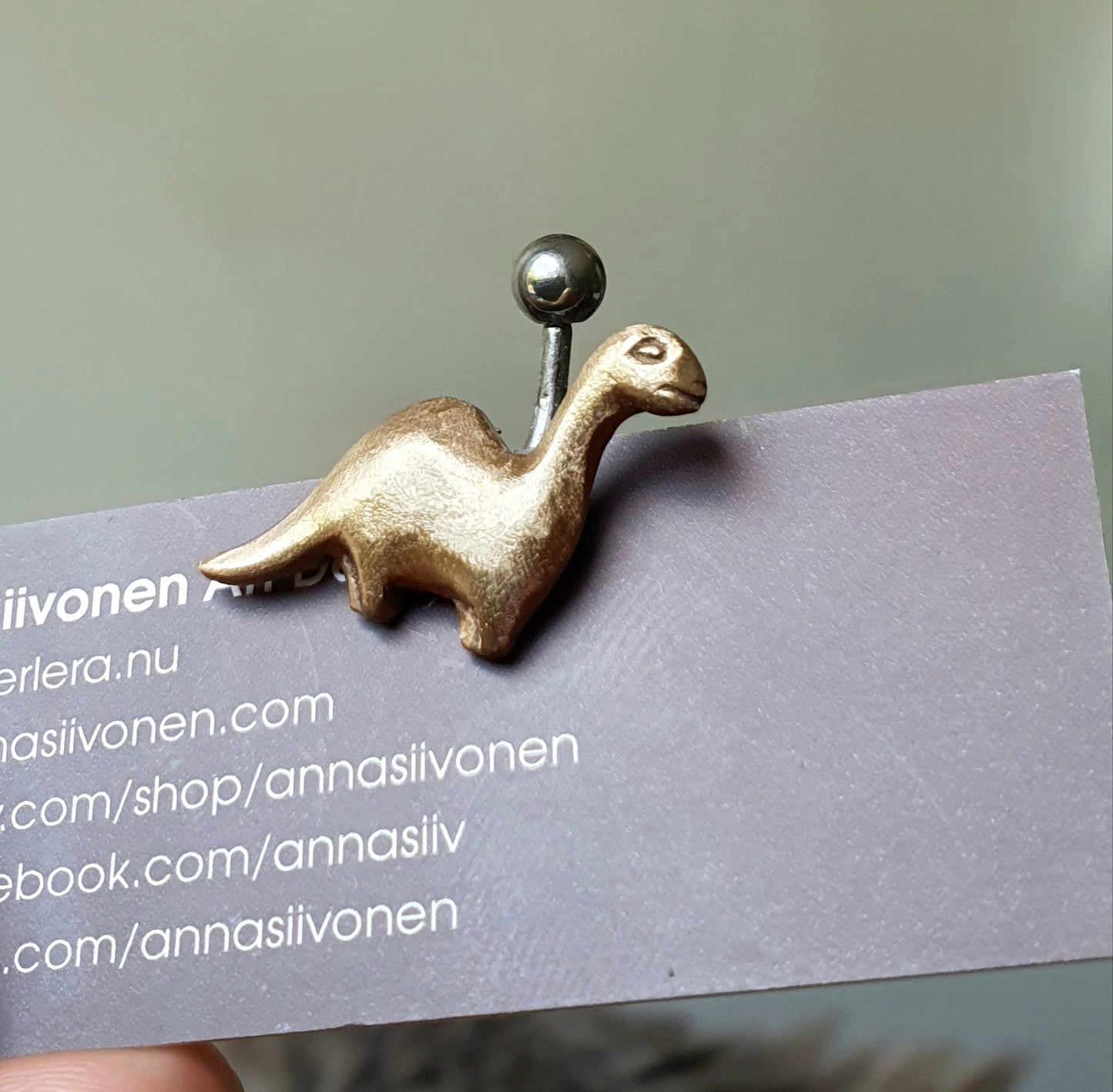 Abronze brachiosaurus dinosaur belly ring with titanium barbell