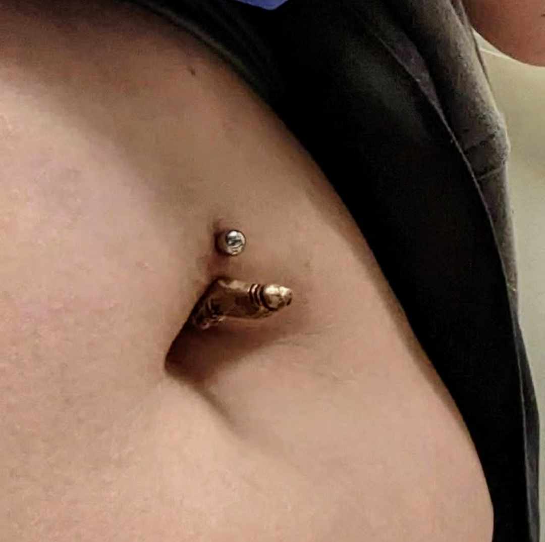 miniature dick bellyring in place in a naval piercing