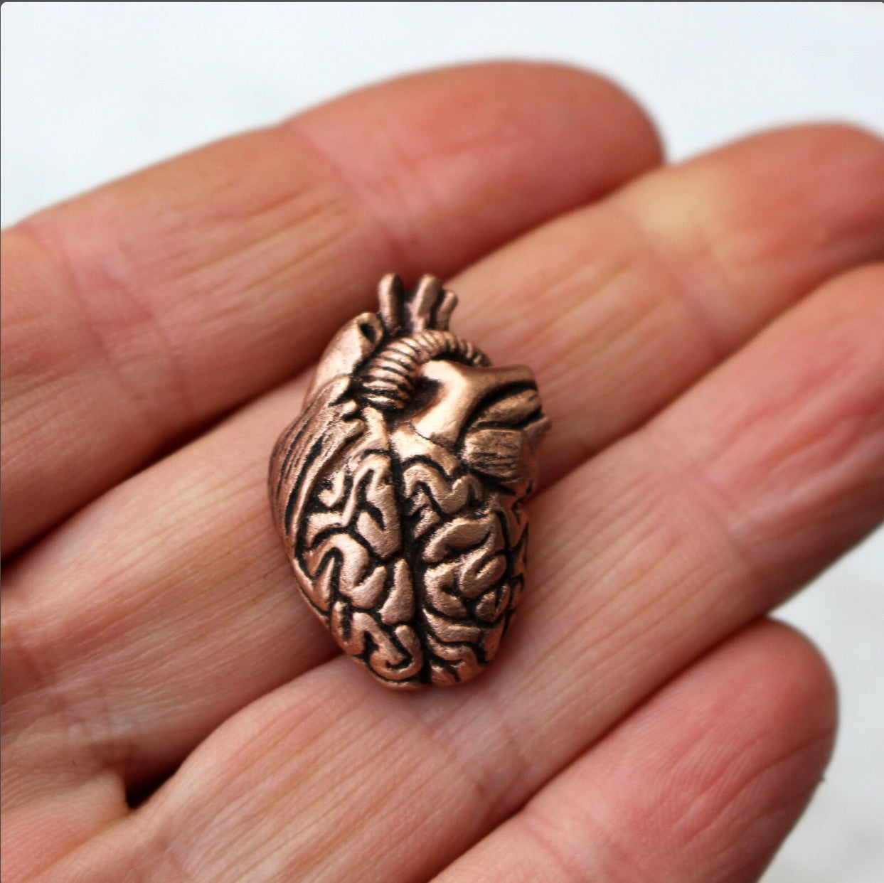 a surreal miniature sculpture, mix of a brain and heart
