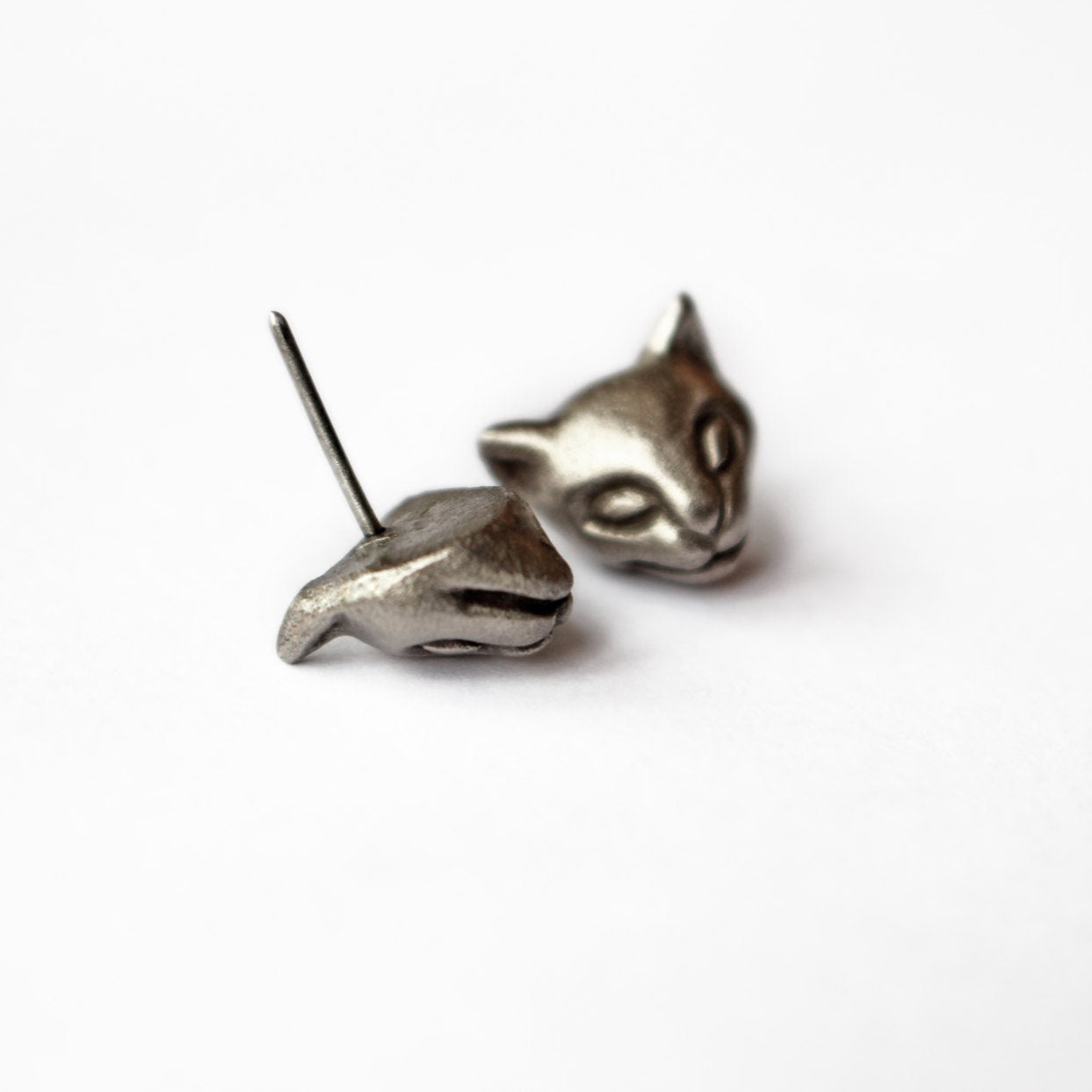 Silver cat-shaped earrings on a white background