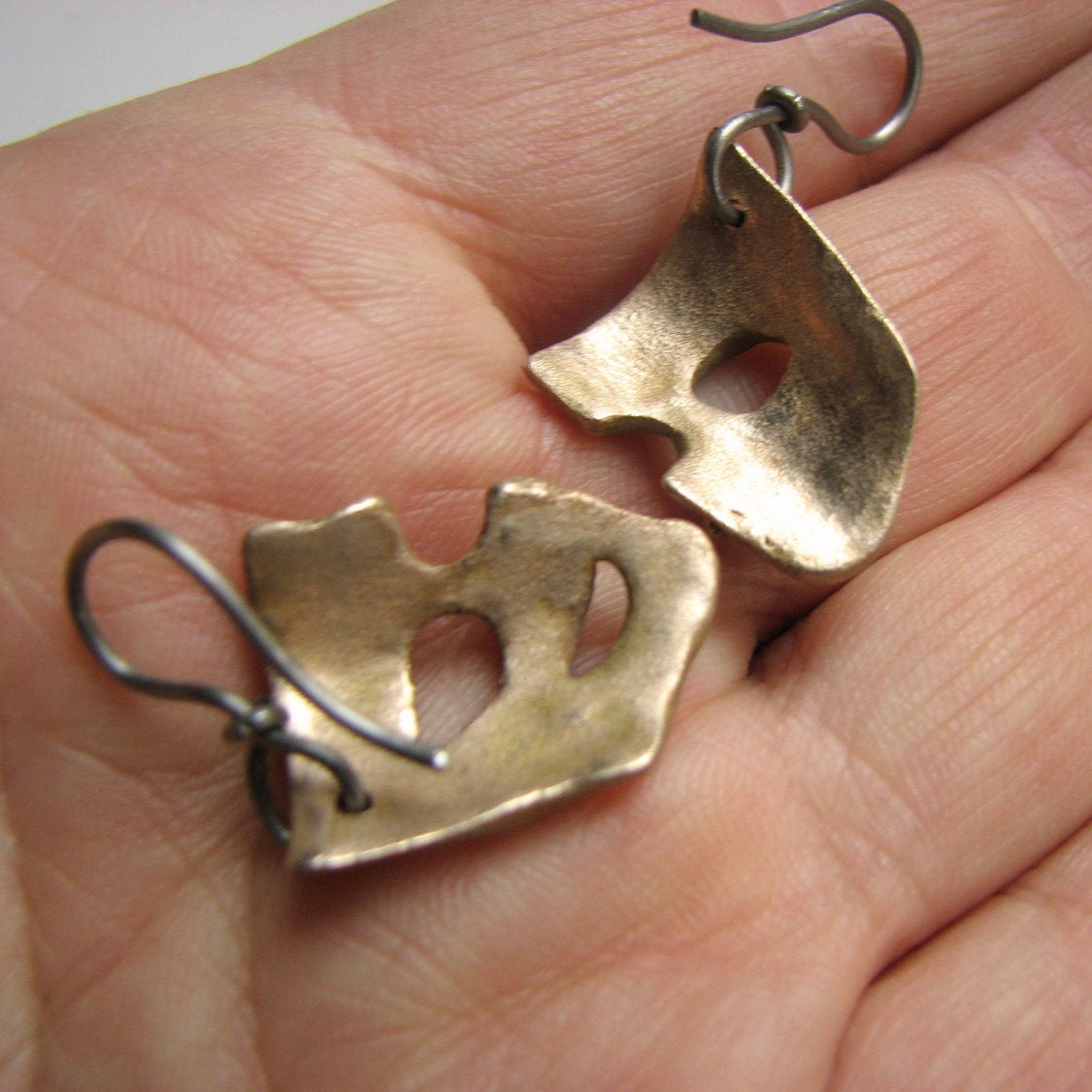 backside mask titanium earrings