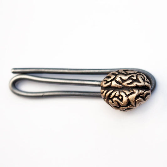A bronze brain tie bar with a simplified human anatomy design, attached to a stainless steel wire clip.