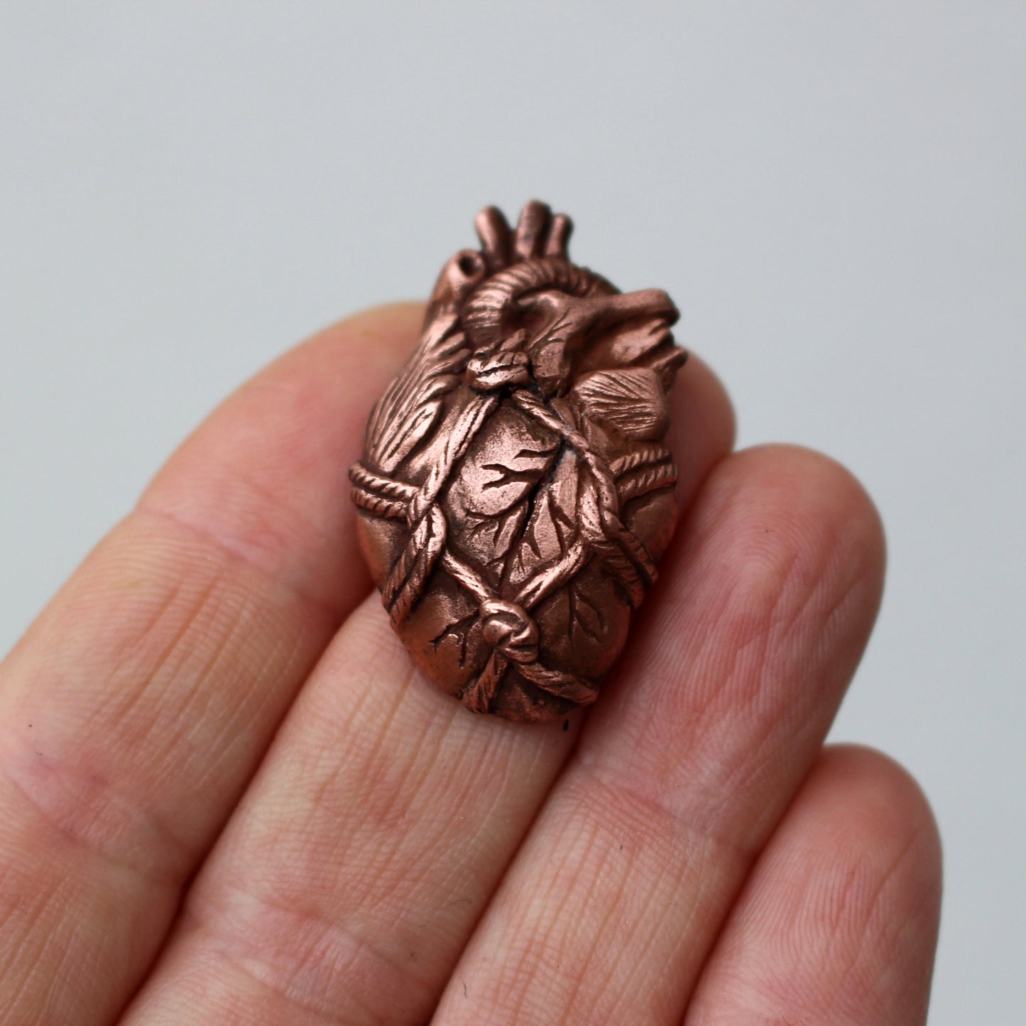 Brosh med ett skulptera anatomiskt hjärta bundet med rep, shibari smycke