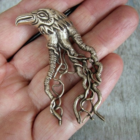 bird head pendant with intricate filigree designs, inspired by tattoo