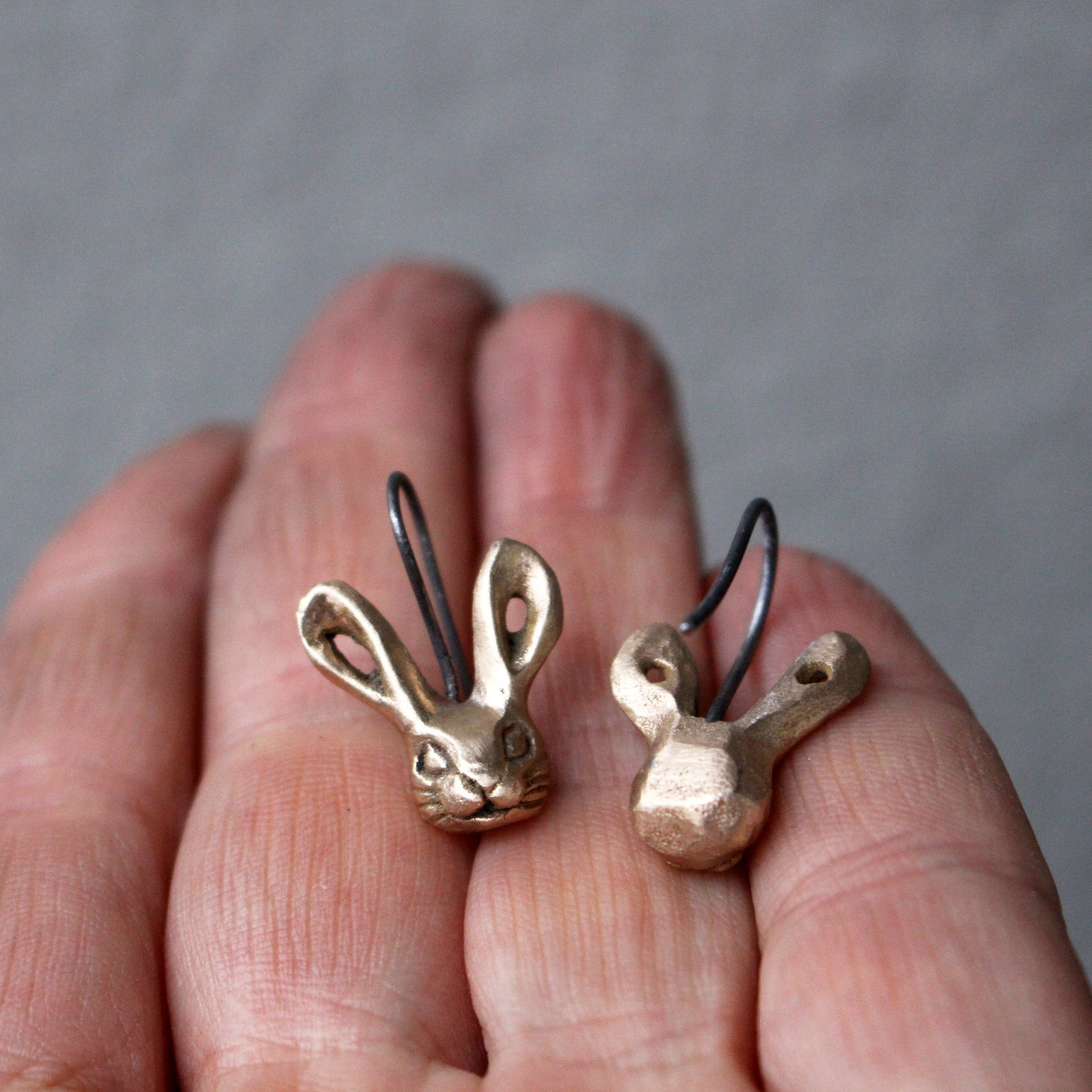 A pair of bronze bunny rabbit earrings with titanium ear wires