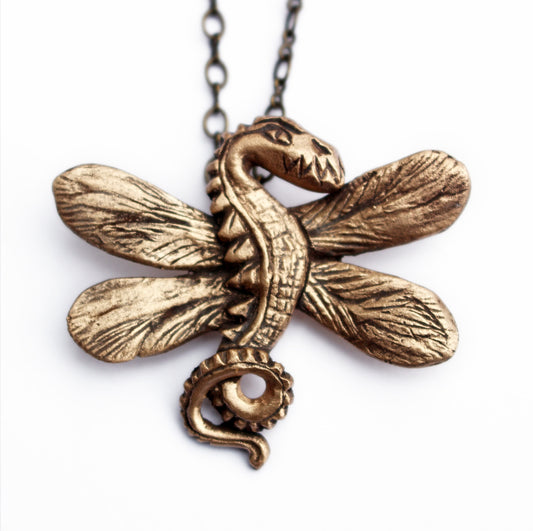 A bronze necklace in the shape of a dragonfly dragon with detailed wings and body, displayed against a white background.