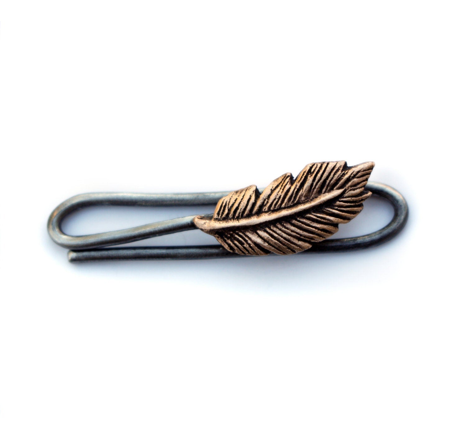 A bronze feather tie bar with a stainless steel clip.