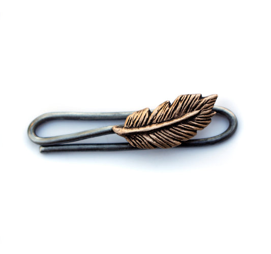 A bronze feather tie bar with a stainless steel clip.
