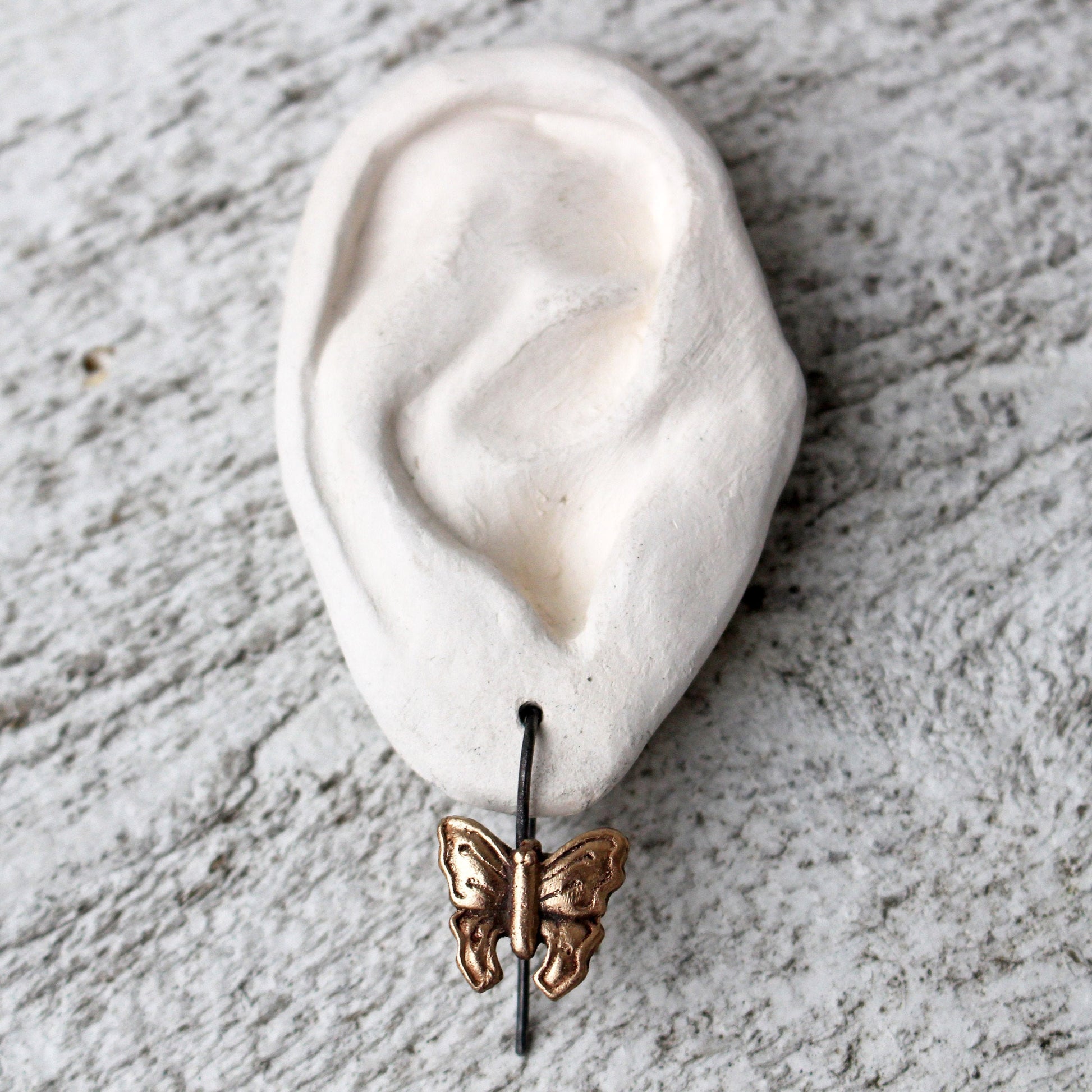 fjärilsörhängen i titan och brons