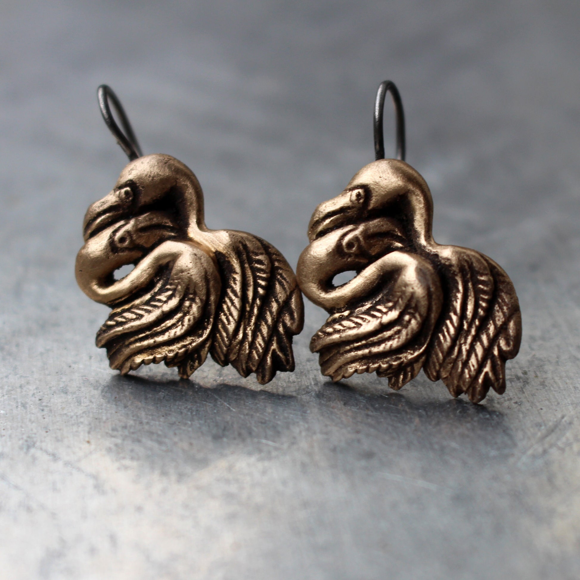 A pair of handmade flamingo earrings made of sterling silver or bronze