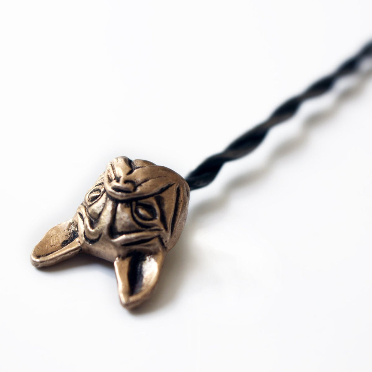 steel hairstick with the head of a french bulldog sculpted in bronze