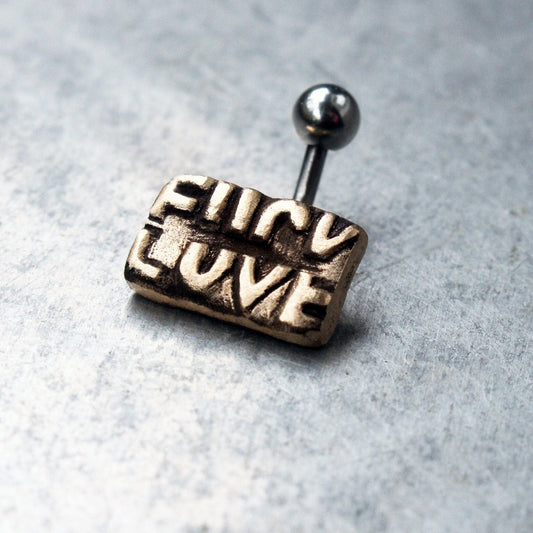 titanium belly button jewelry with the text fuck love sculpted in bronze 