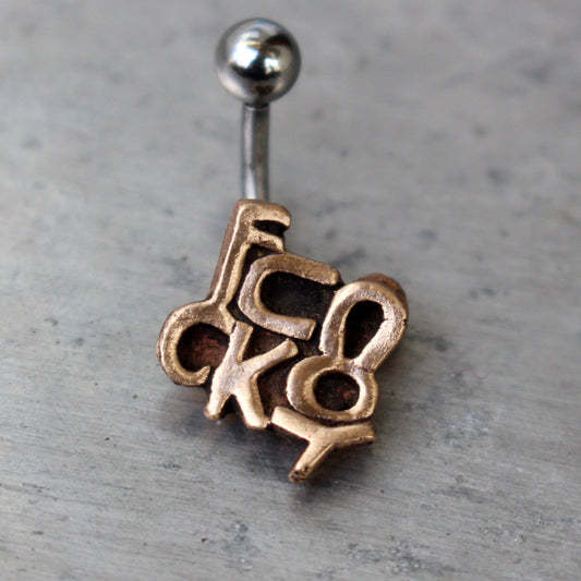 belly button jewelry that spell out the phrase "FUCK YOU" carved in bronze. with a curved barbell, made from either titanium or surgical steel