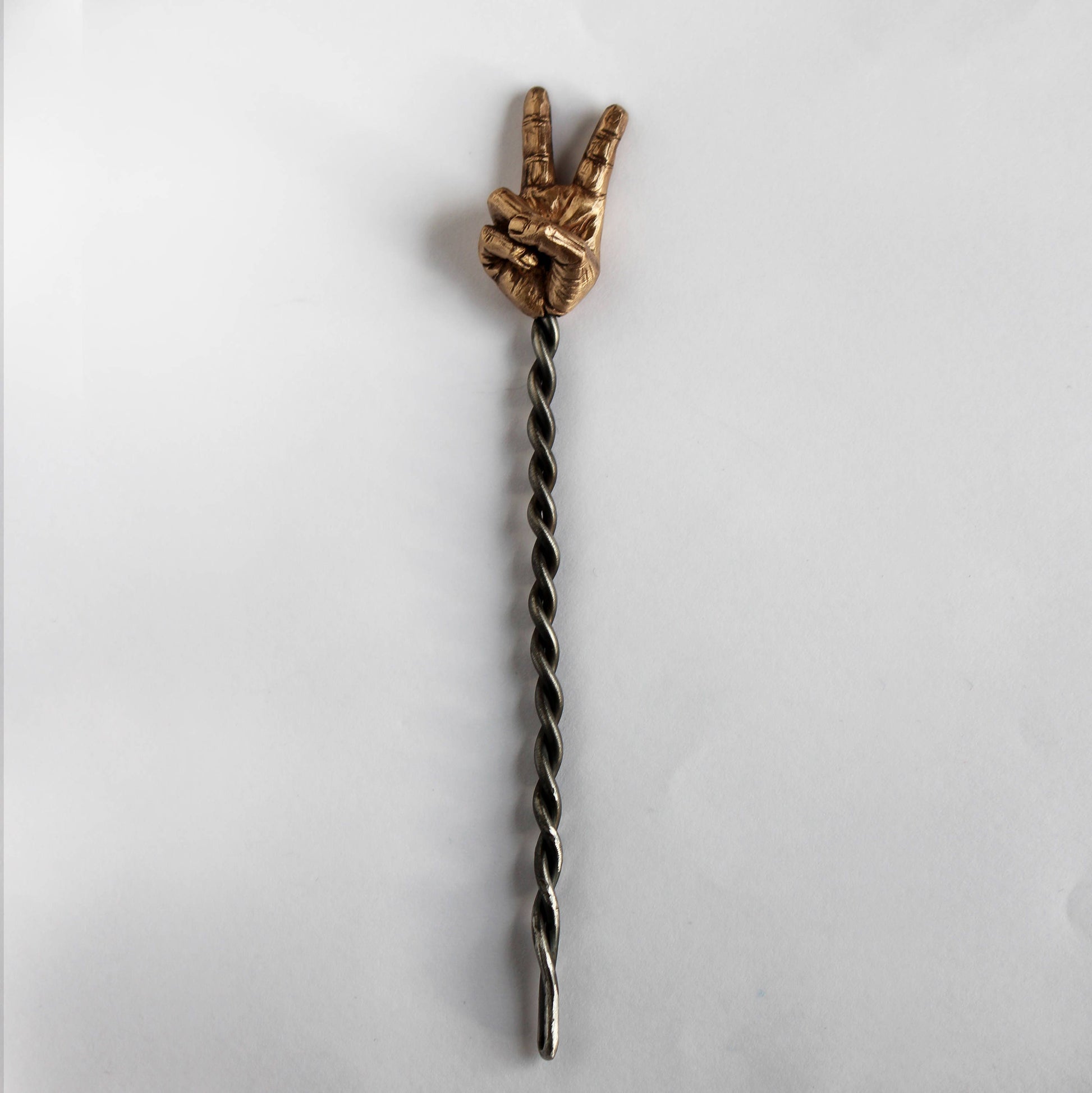 hair jewelry with a sculpted miniature hand making a peace sign with a forged stick from stainless steel