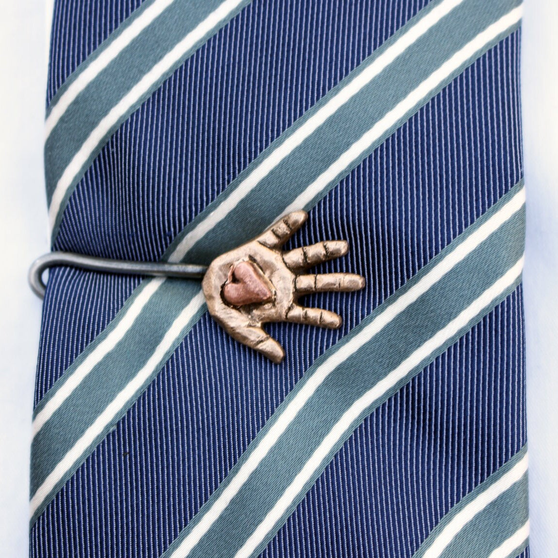 heart in had tie pin