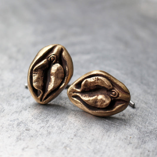 Pussy cuff links. Vagina art