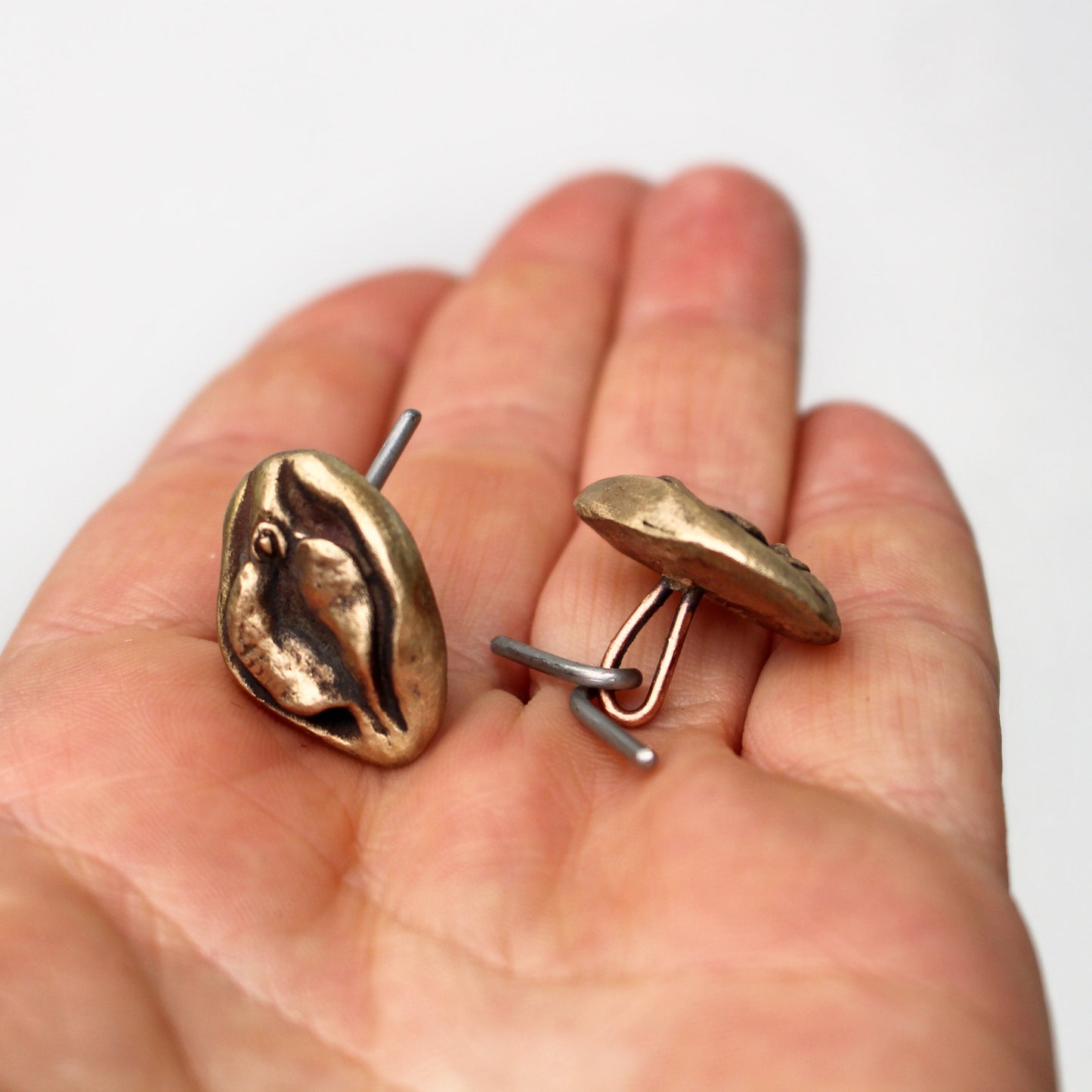 Pussy cuff links. Vagina art