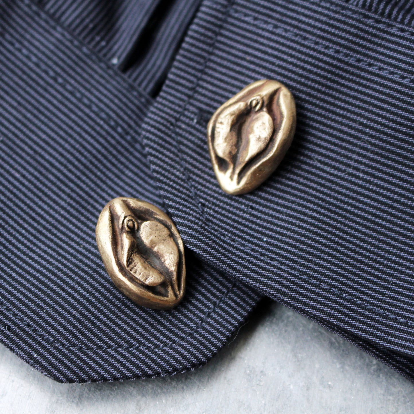 Pussy cuff links. Vagina art