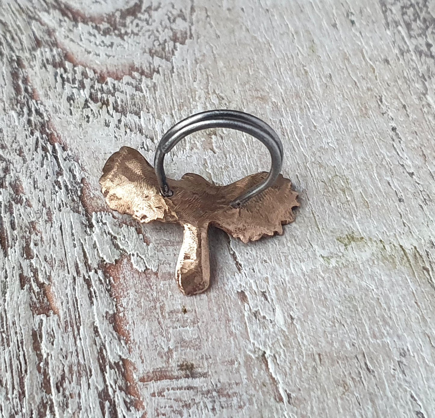 backside of a bronze and steel bird in flight statement ring