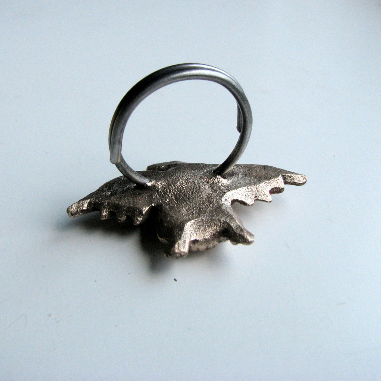 backside of bronze and steel penguin ring
