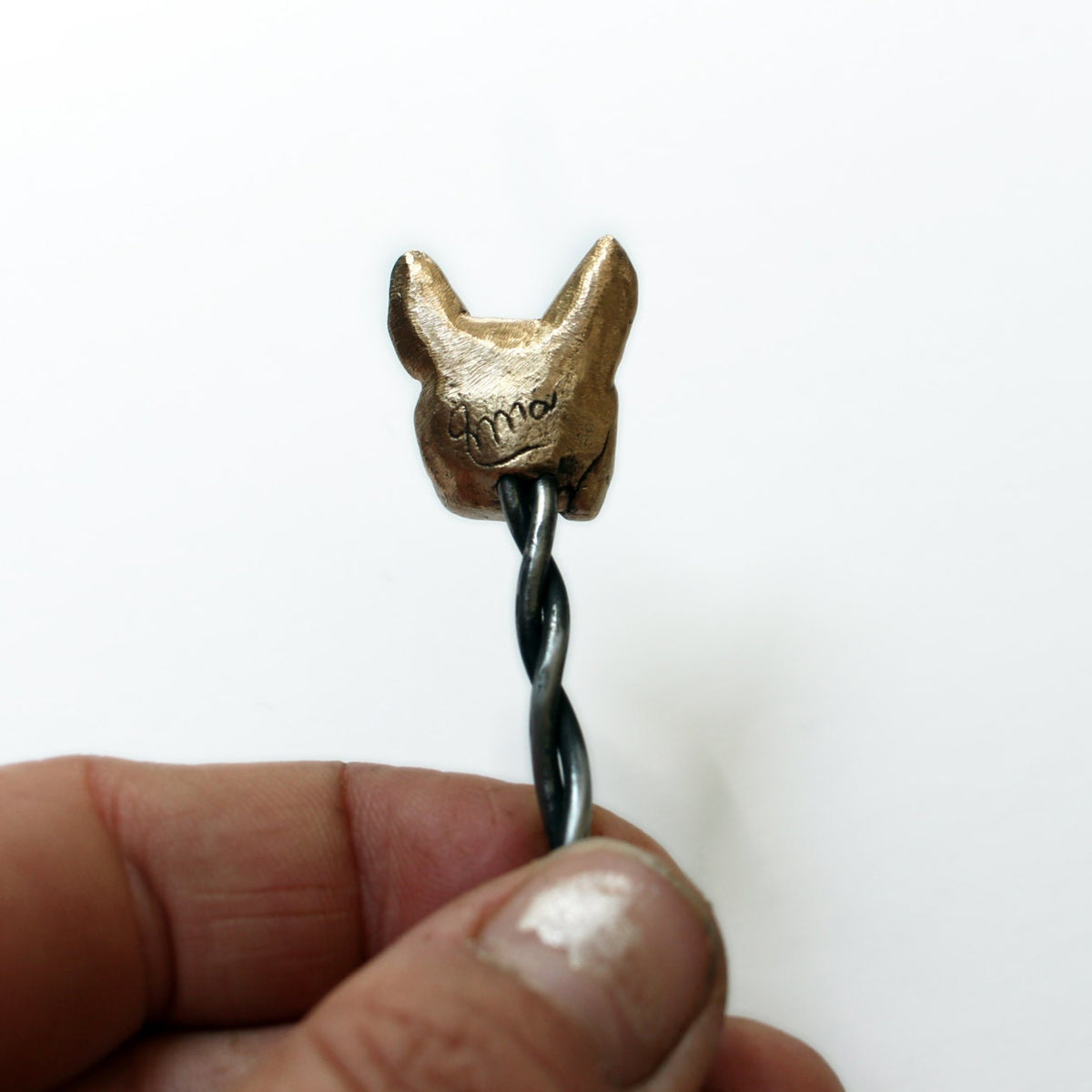 backside view of steel hairstick with the head of a french bulldog sculpted in bronze