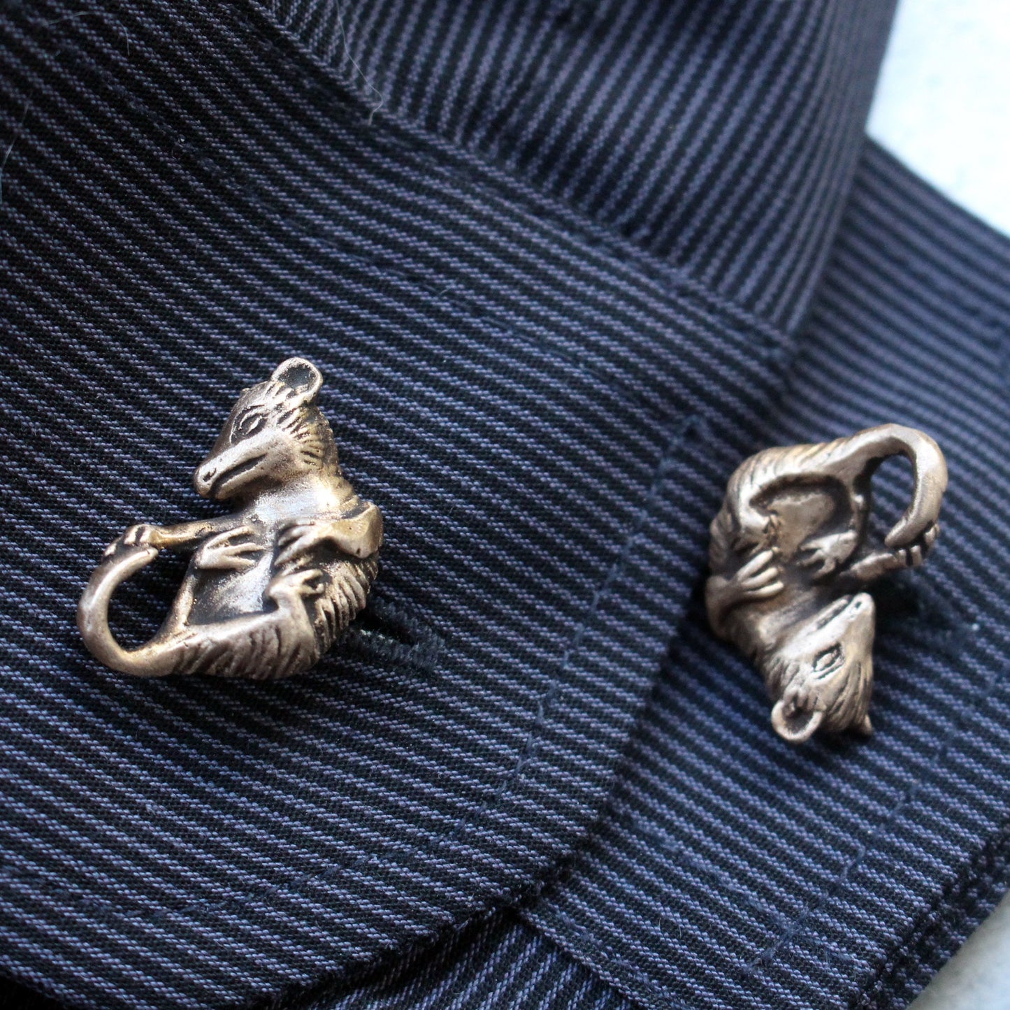 opossum maschettknappar