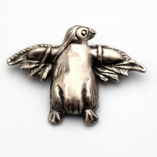 silver miniature sculpture of a penguin with extra wings