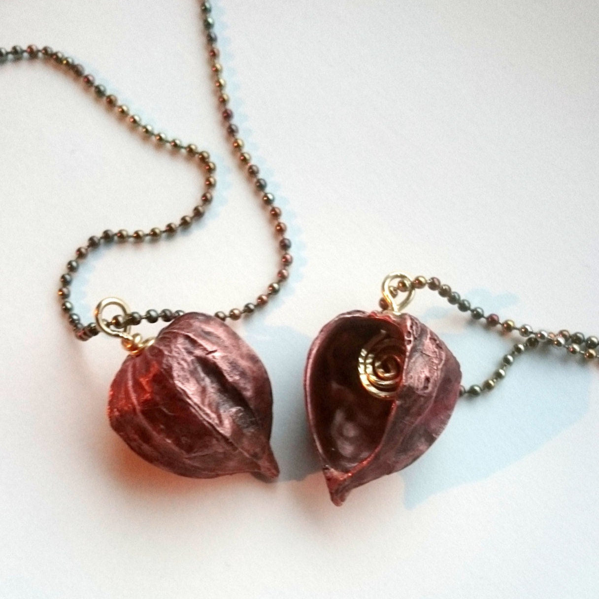 två physalishalsband i koppar