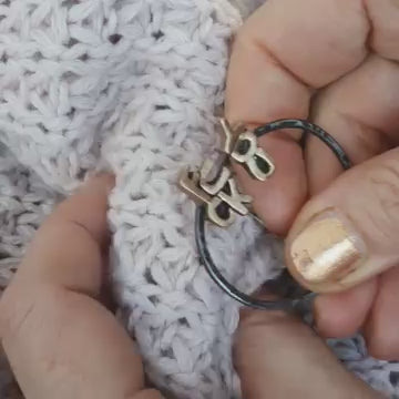 brooch forged in stainless steel and bronze that sais fuck you