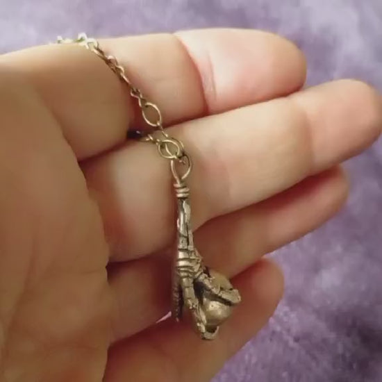 bird claw pendant sculpted in bronze