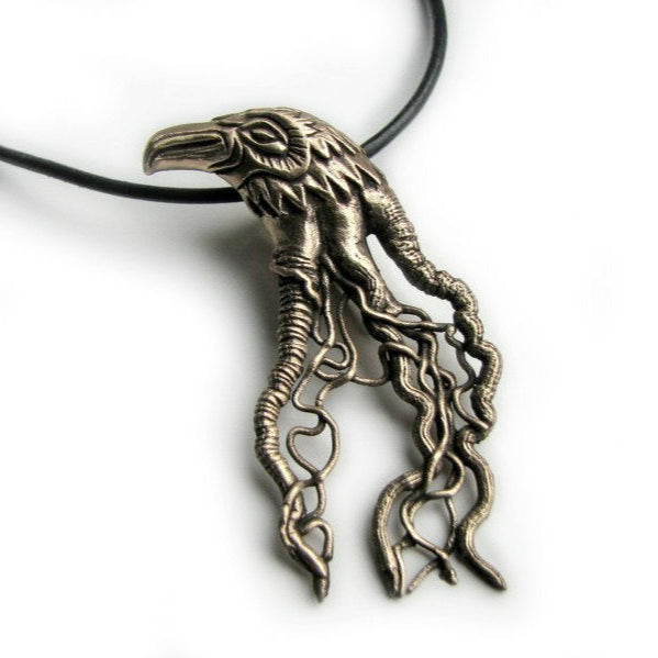 Bird head pendant in bronze with intricate filigree design