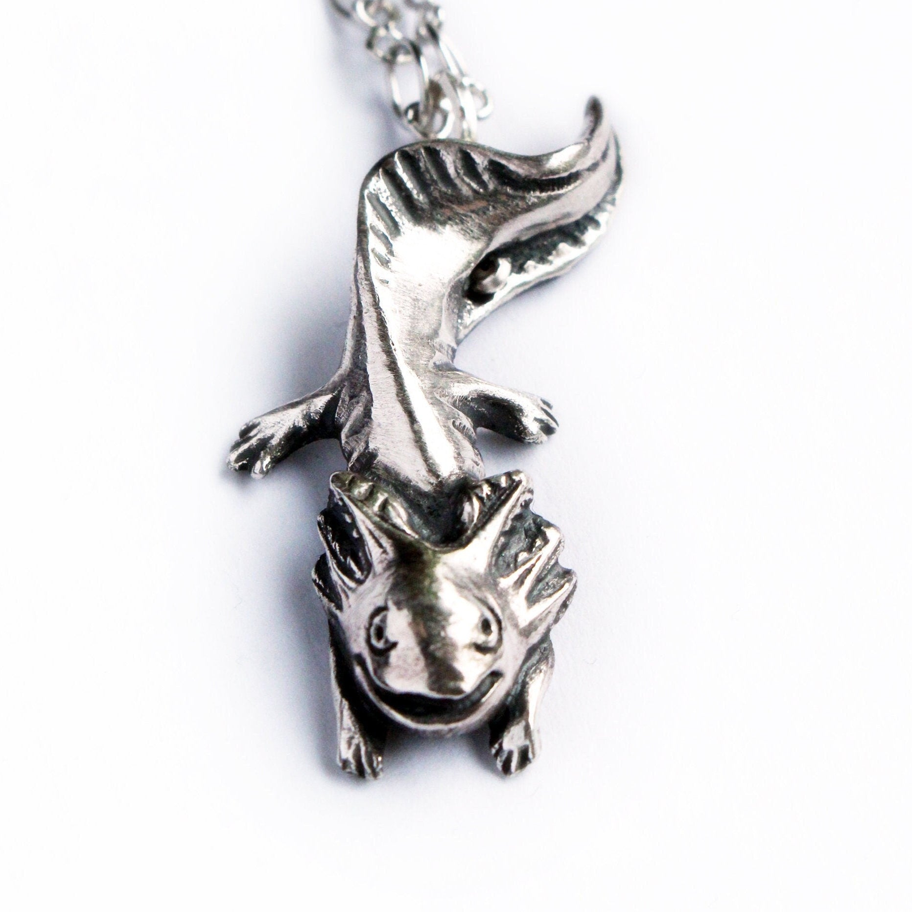 sterling silver axolotl necklace on a white background