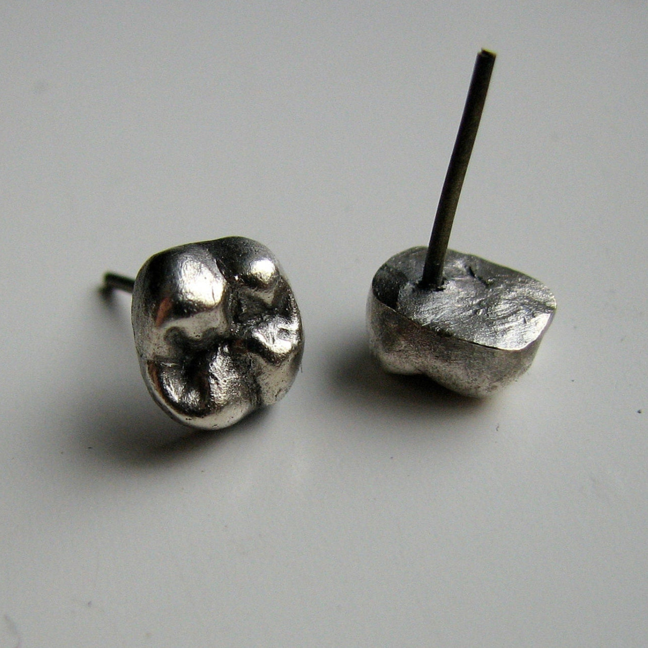 cast silver tooth earrings