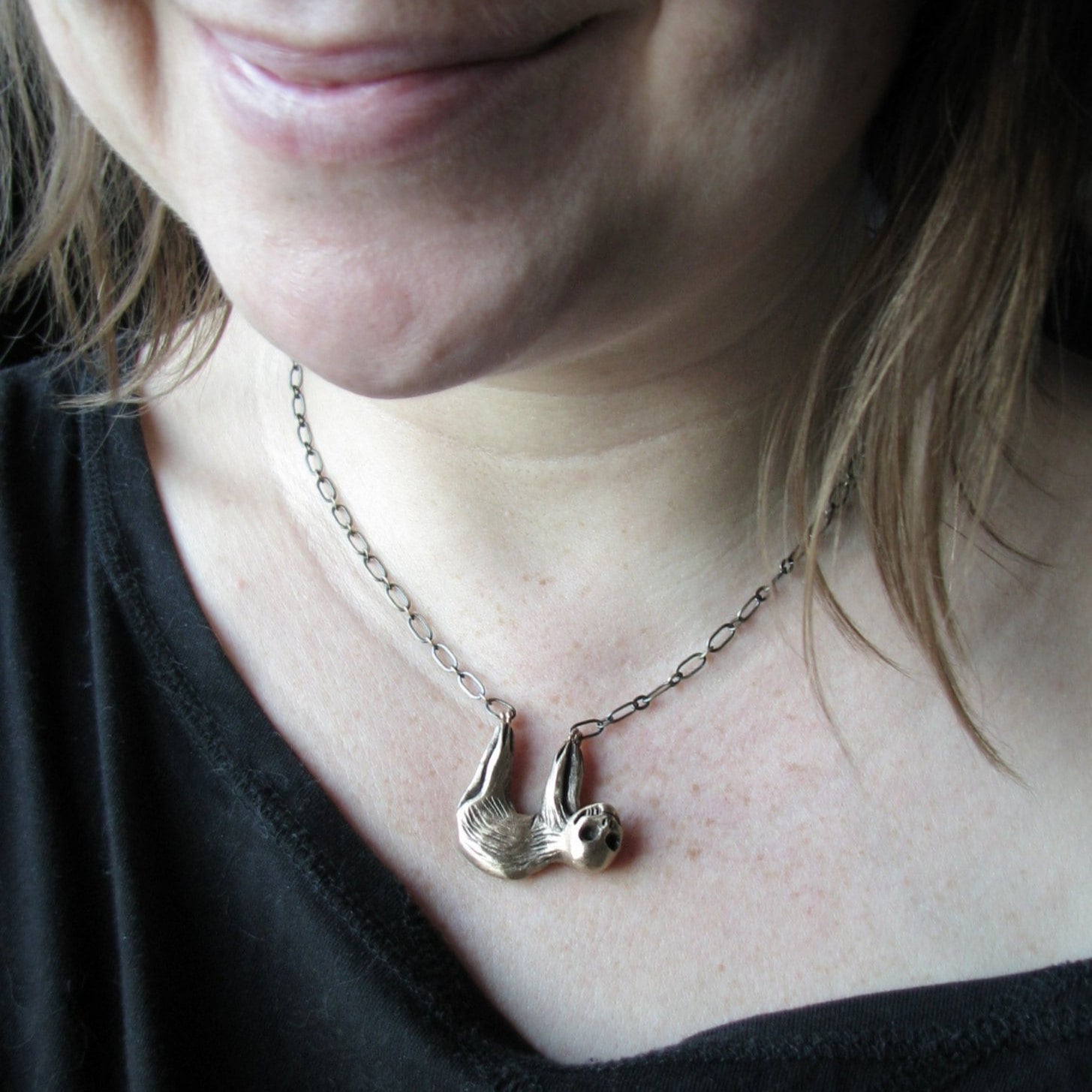 surreal necklace with a sloth with a skull head handcrafted in bronze