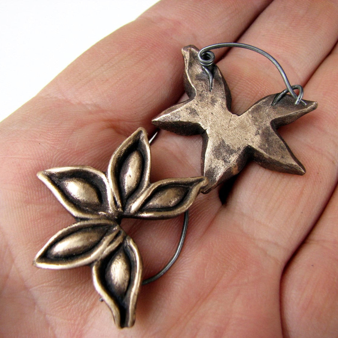 bronze and titaniuml hoop earrings with star anise seed pods