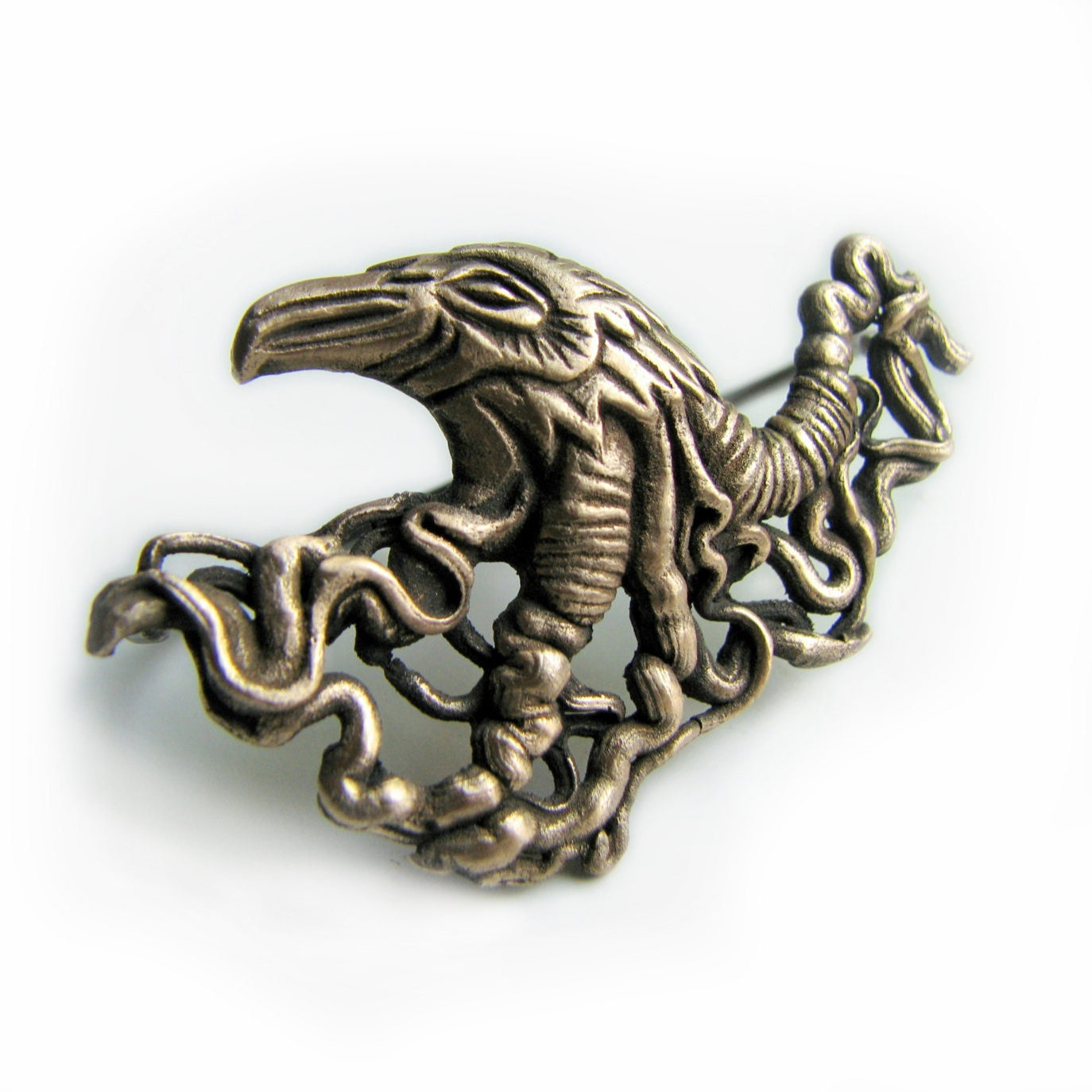 Raven knuckle duster ring for two fingers. Delicate filigree shaped like veins and intestines or perhaps tree roots grow from the bird's head