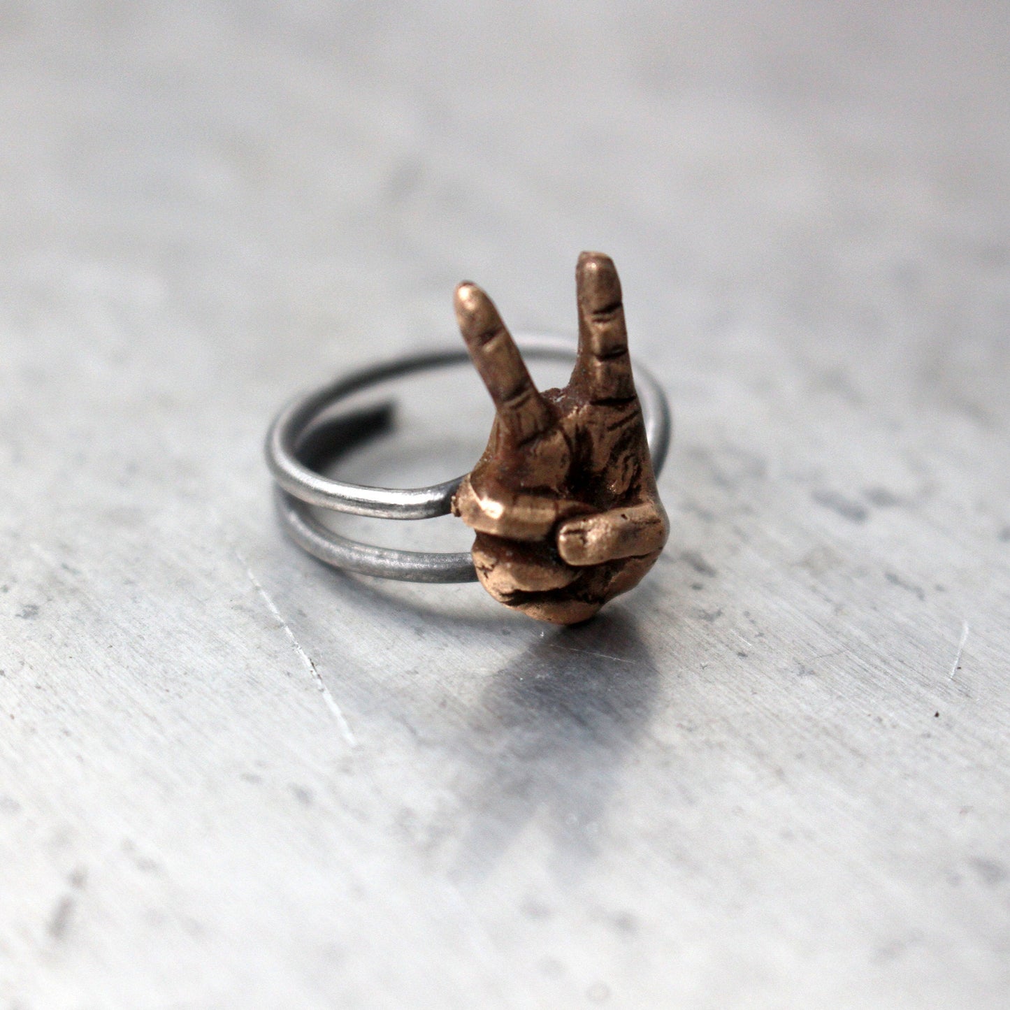 victory sign ring, hand making a peace sign