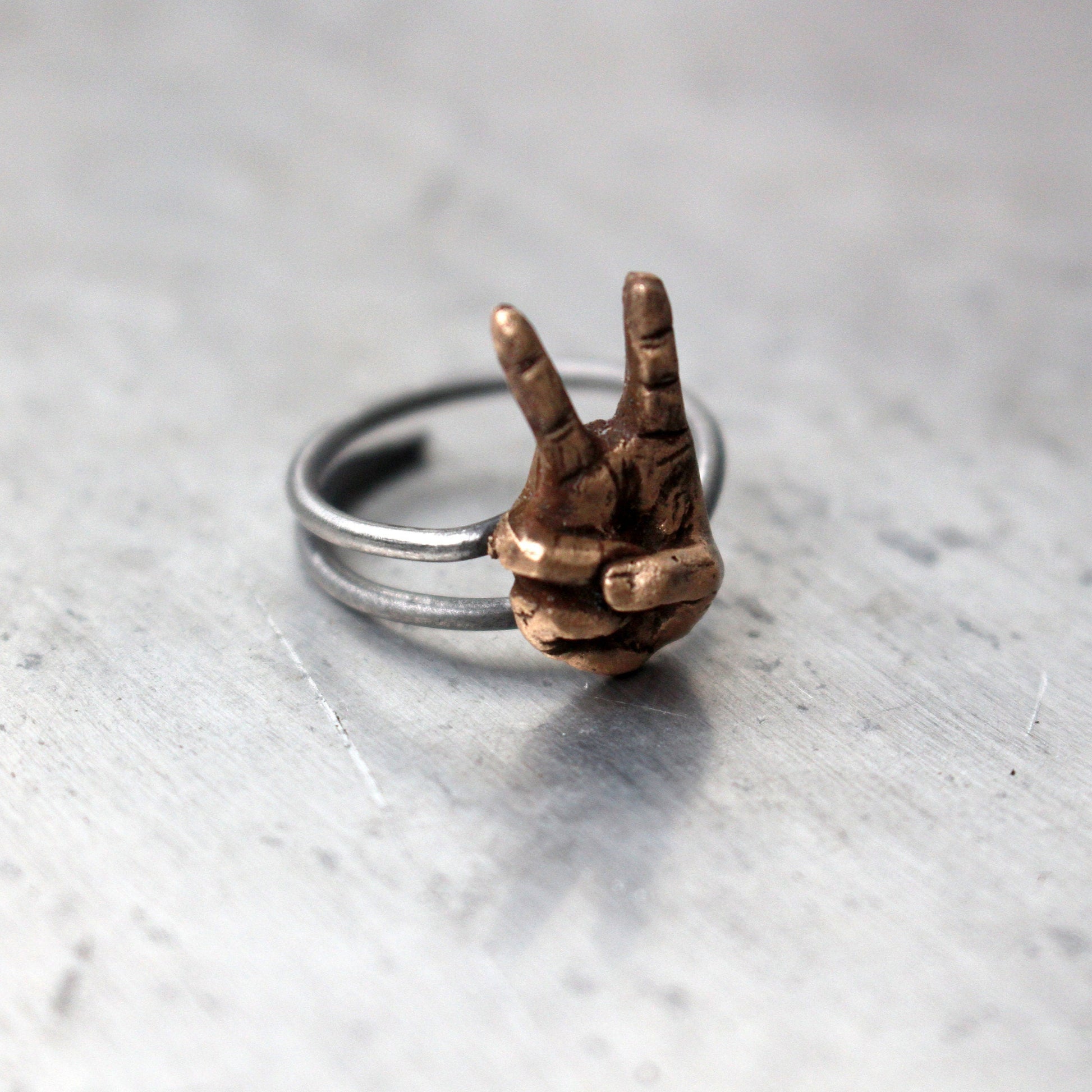 victory sign ring, hand making a peace sign