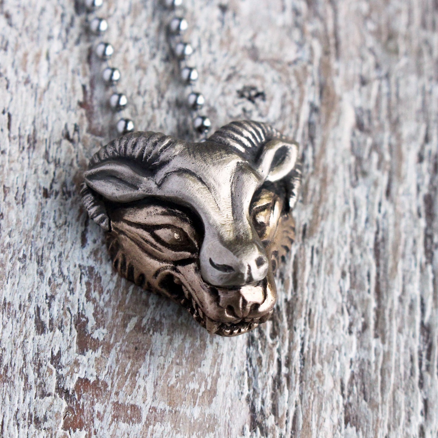 wolf in sheeps clothes necklace, the wolf head made in yellow bronze and the sheep mask in white bronze