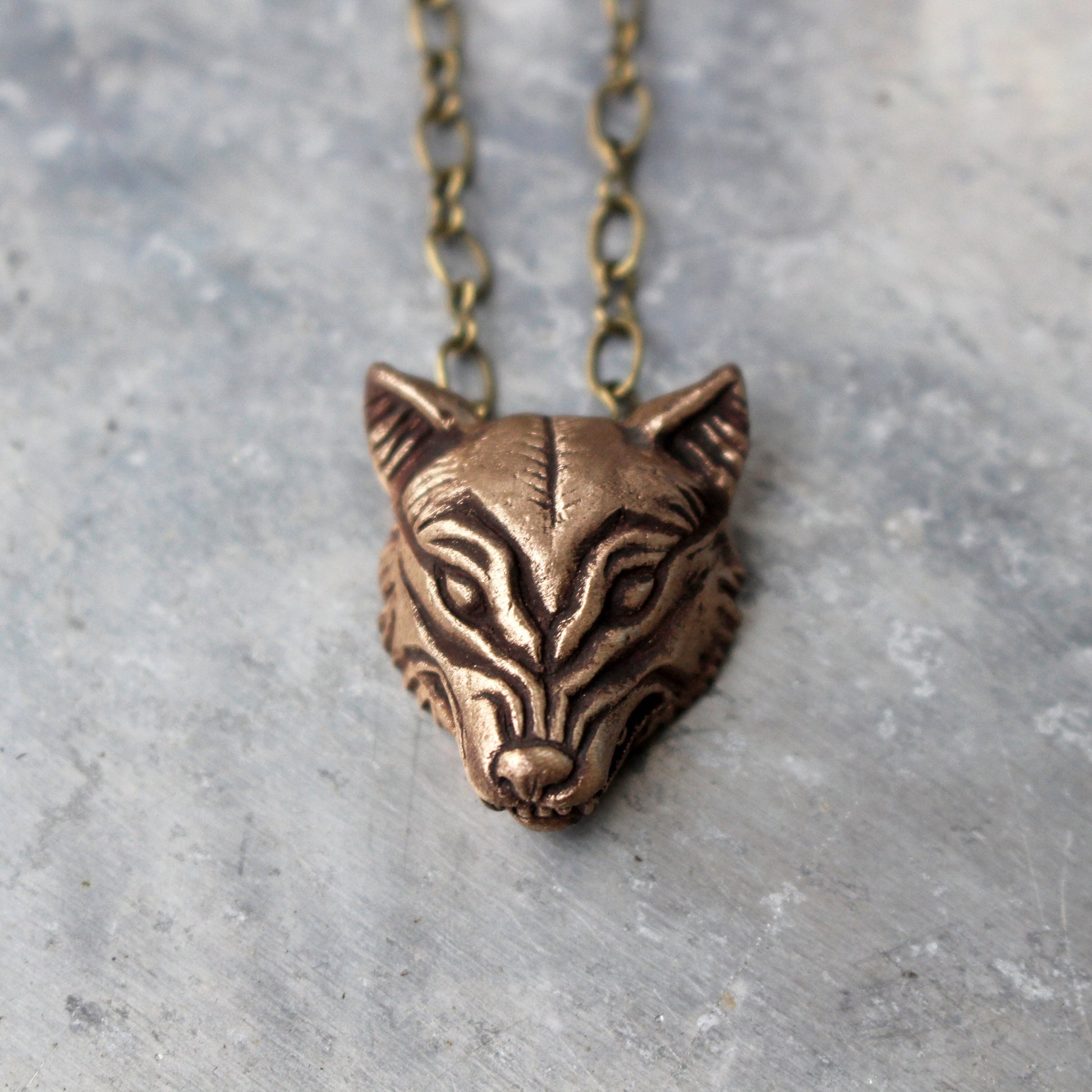 wolf head charm in bronze